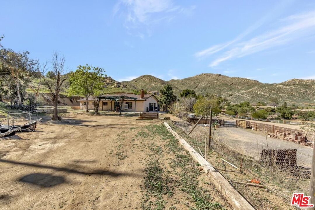 11455 Pigeon Pass Road Moreno Valley, CA 92557 - Photo 17 of 48 a view of a house with a yard