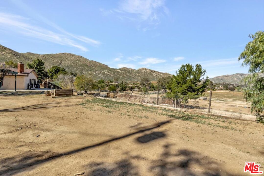 11455 Pigeon Pass Road Moreno Valley, CA 92557 - Photo 18 of 48 a view of a yard with a house