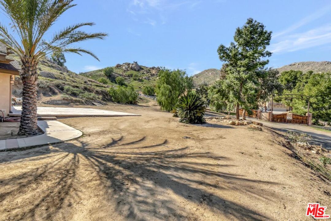 11455 Pigeon Pass Road Moreno Valley, CA 92557 - Photo 6 of 48 a view of a yard with plants and trees