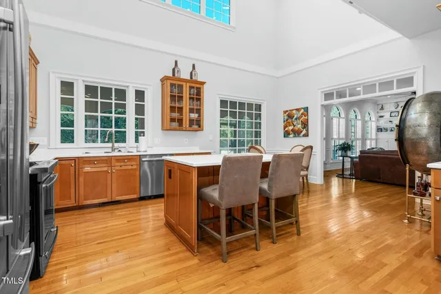 a kitchen with a stove a sink dishwasher a microwave oven with granite countertops and cabinets