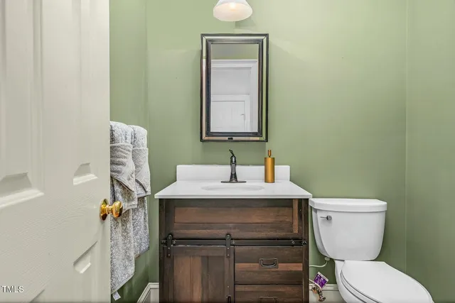 a kitchen with stainless steel appliances granite countertop a refrigerator a sink dishwasher a stove with wooden cabinets and floor