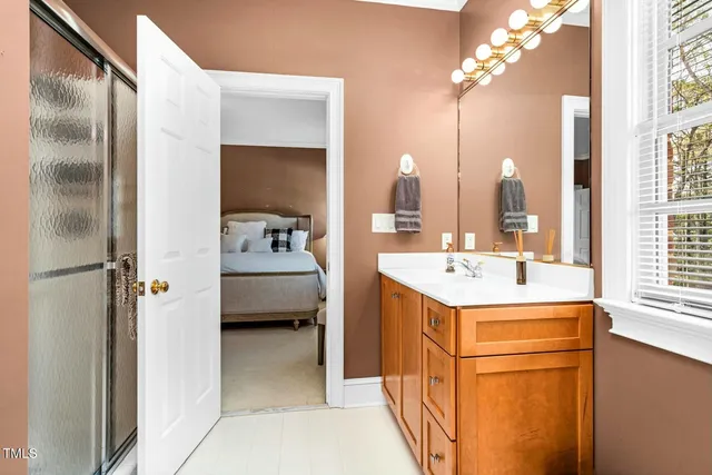 a bathroom with a sink a toilet and shower curtain