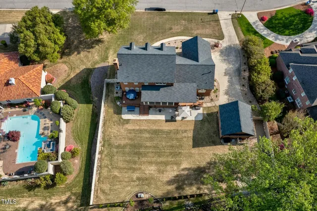 an aerial view of a house with a yard and potted plants