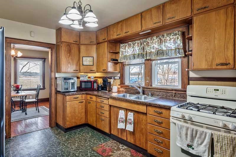 16905 West State Road Pecatonica, IL 61063 - Photo 15 of 36 a kitchen with stainless steel appliances granite countertop a stove a sink dishwasher and cabinets with wooden floor