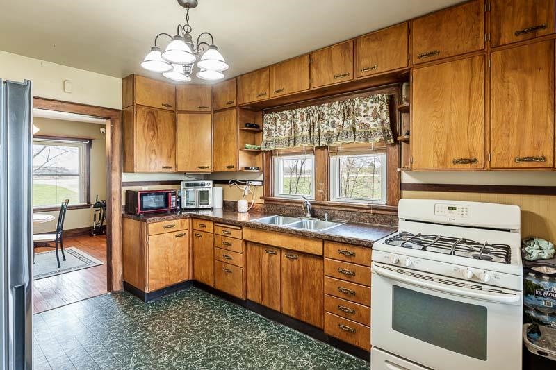 16905 West State Road Pecatonica, IL 61063 - Photo 15 of 47 a kitchen with stainless steel appliances a stove a sink and a refrigerator