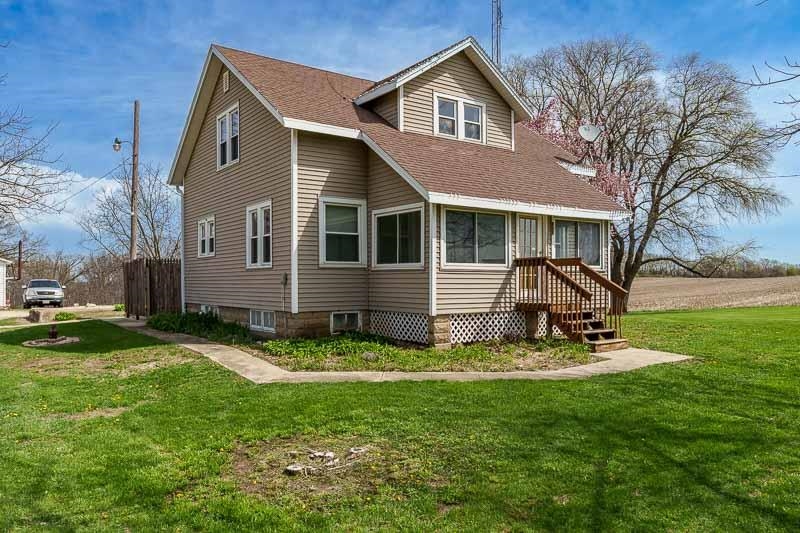 16905 West State Road Pecatonica, IL 61063 - Photo 2 of 47 a view of a backyard with table and chairs and a yard