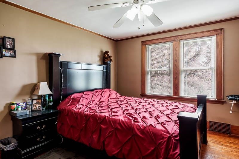 16905 West State Road Pecatonica, IL 61063 - Photo 25 of 47 a bedroom with a bed and a chandelier