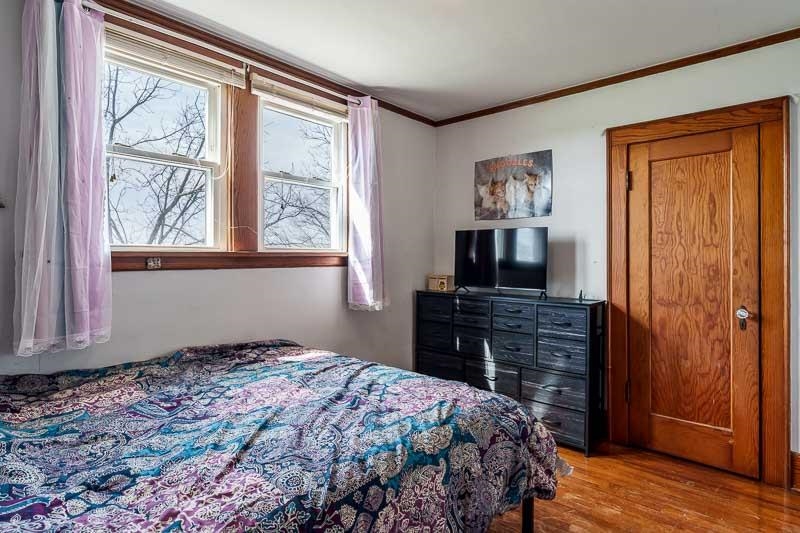 16905 West State Road Pecatonica, IL 61063 - Photo 27 of 47 a bedroom with a bed and wooden floor