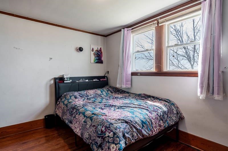 16905 West State Road Pecatonica, IL 61063 - Photo 28 of 47 a bedroom with a bed and wooden floor