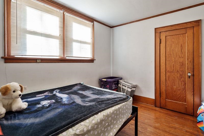 16905 West State Road Pecatonica, IL 61063 - Photo 30 of 36 a bedroom with a bed and wooden floor