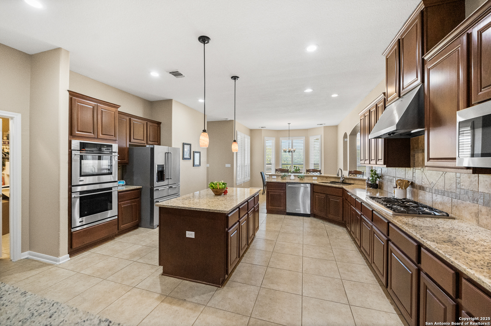 123 Dodder Lane Spring Branch, TX 78070 - Photo 17 of 72 a kitchen with stainless steel appliances granite countertop a sink a stove and a refrigerator