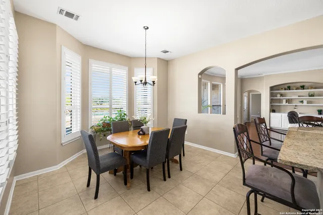 a view of a dining room with furniture and chandelier