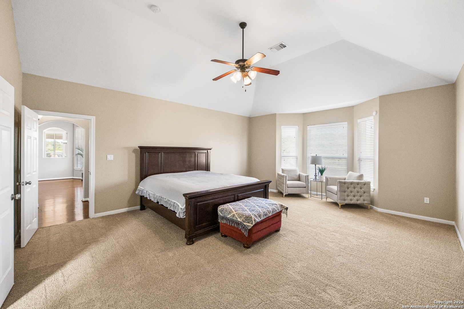 123 Dodder Lane Spring Branch, TX 78070 - Photo 28 of 72 a spacious bedroom with a bed and a chandelier