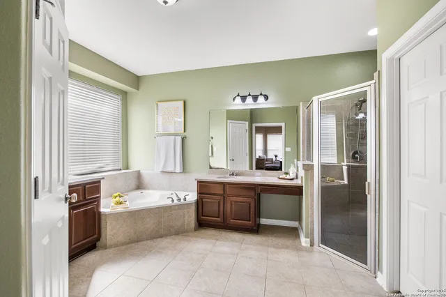 a view of a big room with wooden floor and a chandelier fan
