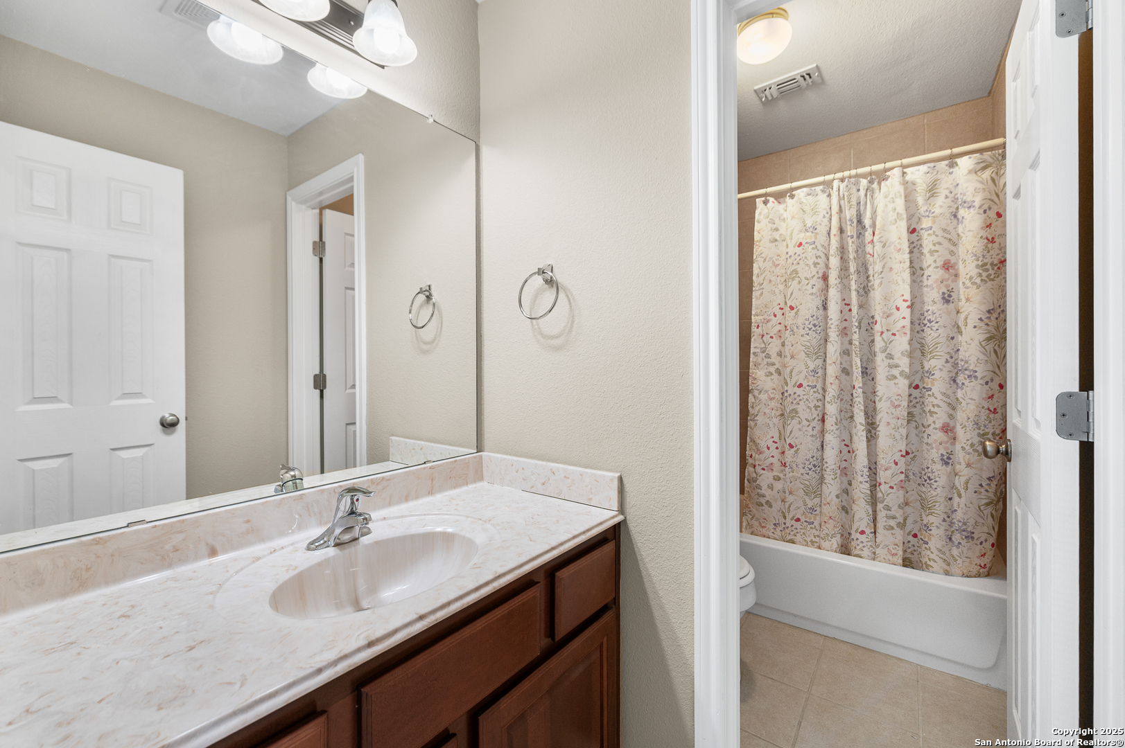 123 Dodder Lane Spring Branch, TX 78070 - Photo 37 of 72 a bathroom with a granite countertop sink and a mirror