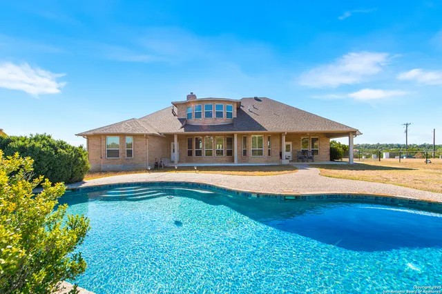 an aerial view of house with a yard