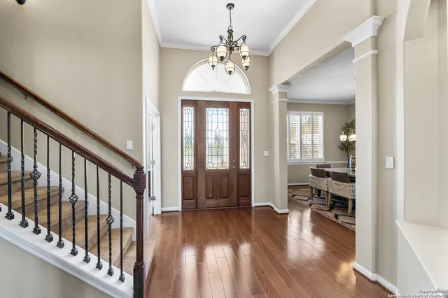 a view of a hallway with wooden floor and entryway