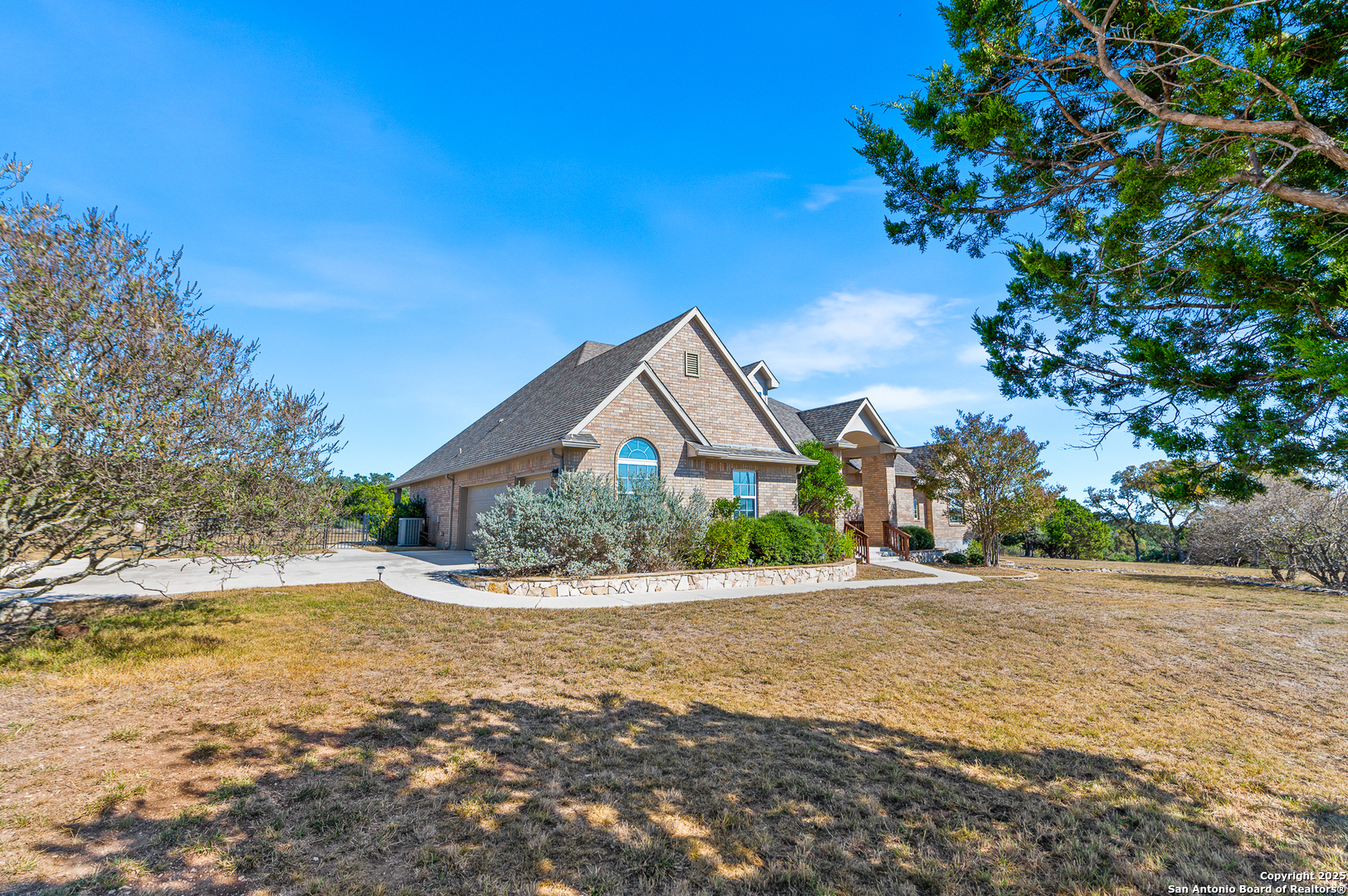 123 Dodder Lane Spring Branch, TX 78070 - Photo 56 of 72 a front view of a house with a yard and a tree