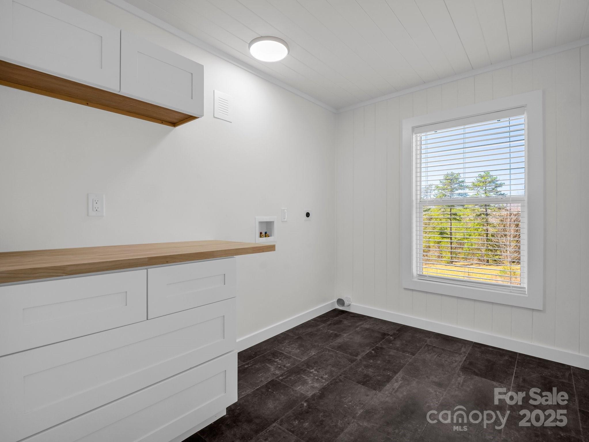 3531 Big Level Road Mill Spring, NC 28756 - Photo 13 of 29 a view of an empty room with wooden floor and a window