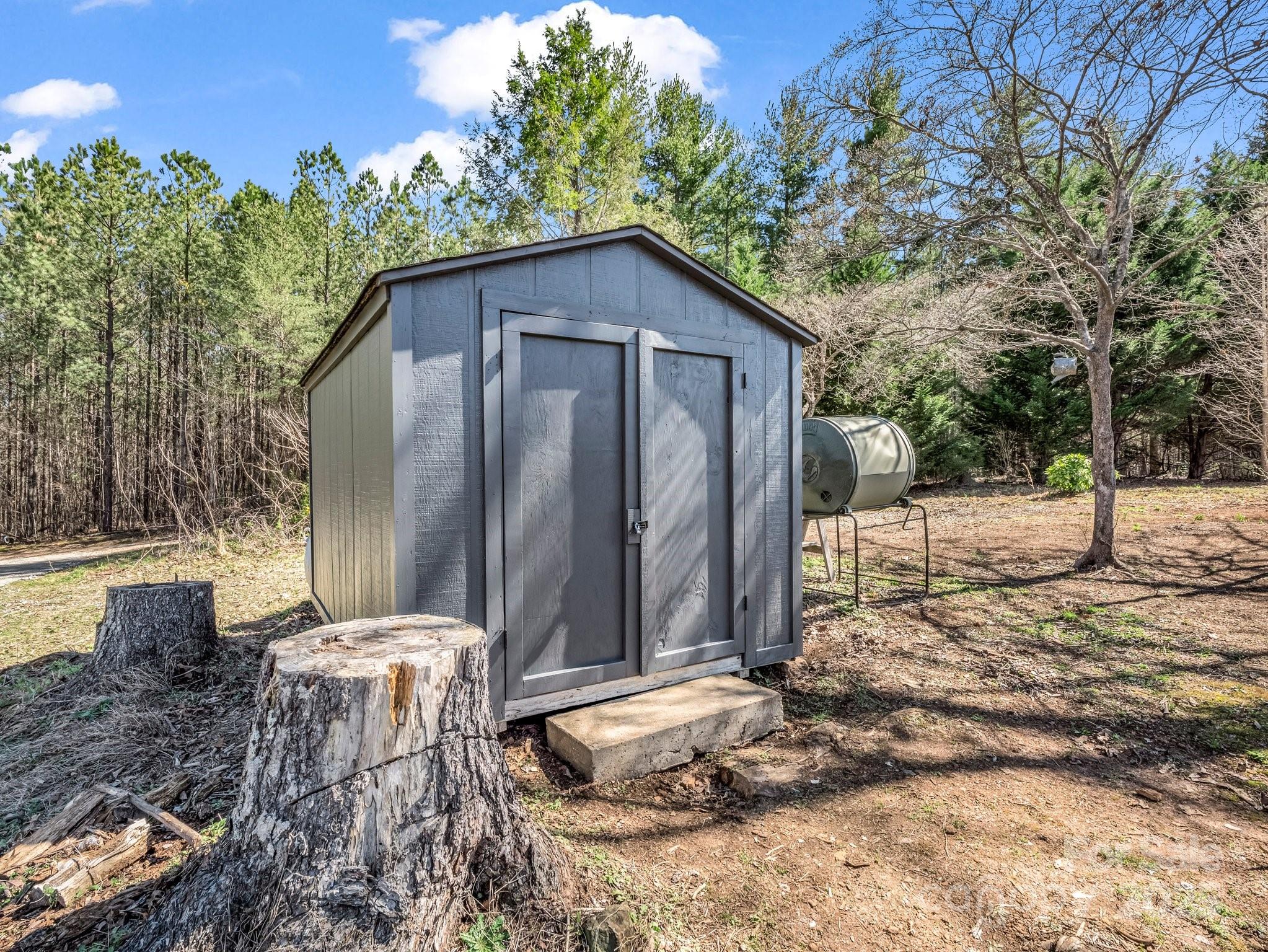 3531 Big Level Road Mill Spring, NC 28756 - Photo 18 of 29 a backyard of a house with table and chairs