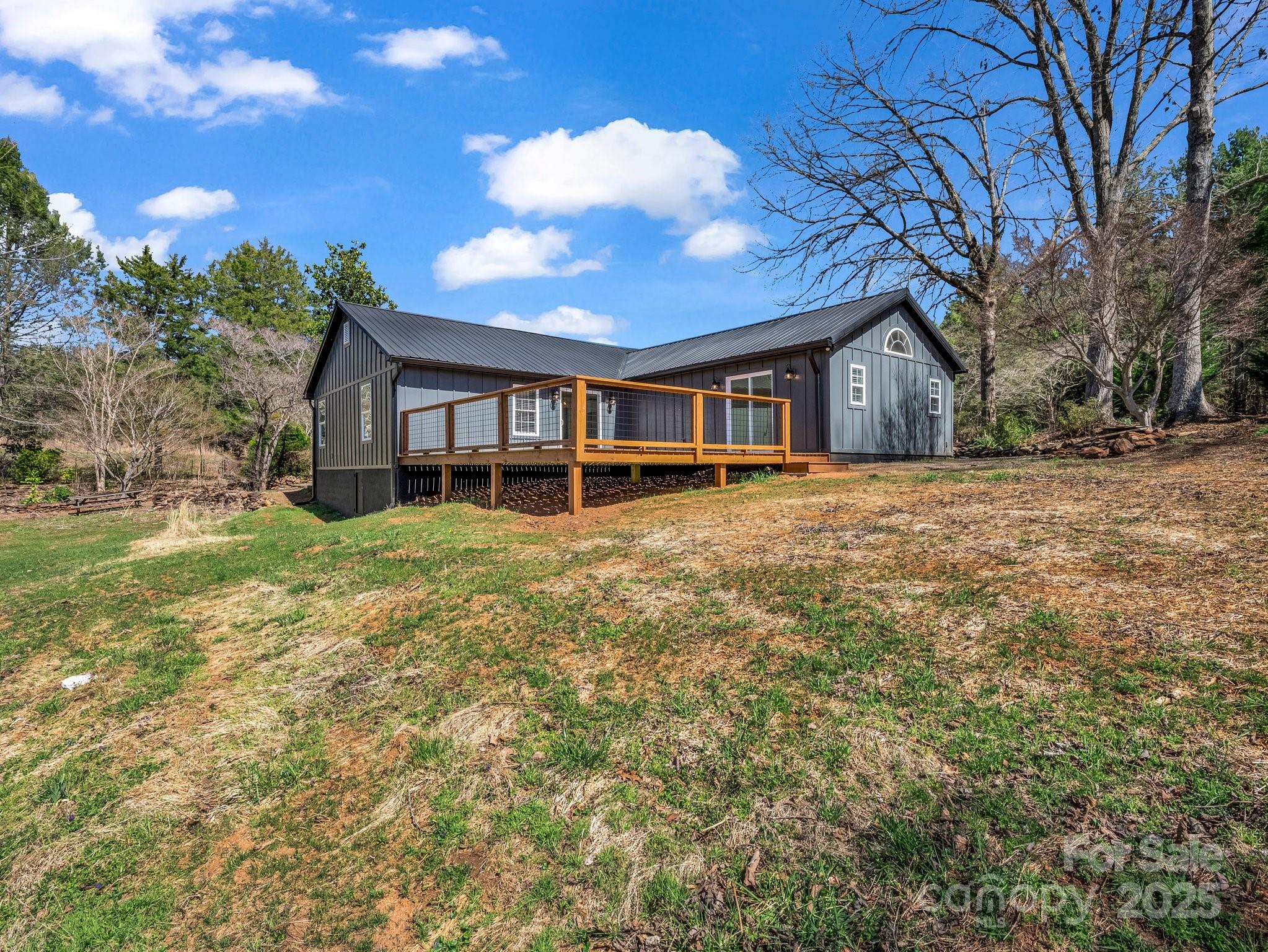 3531 Big Level Road Mill Spring, NC 28756 - Photo 20 of 29 a view of a house with yard and sitting area