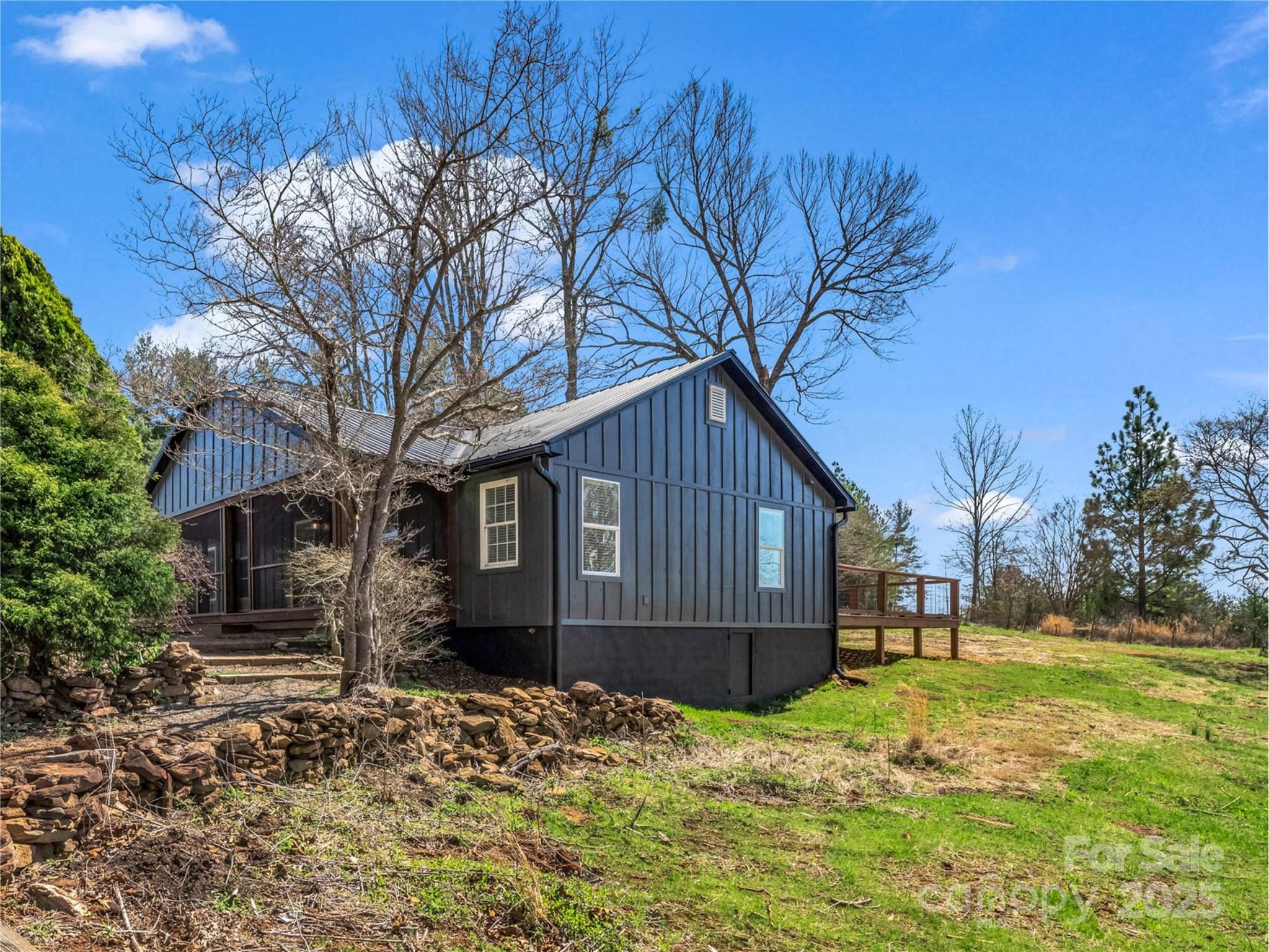 3531 Big Level Road Mill Spring, NC 28756 - Photo 22 of 29 a backyard of a house with a large tree