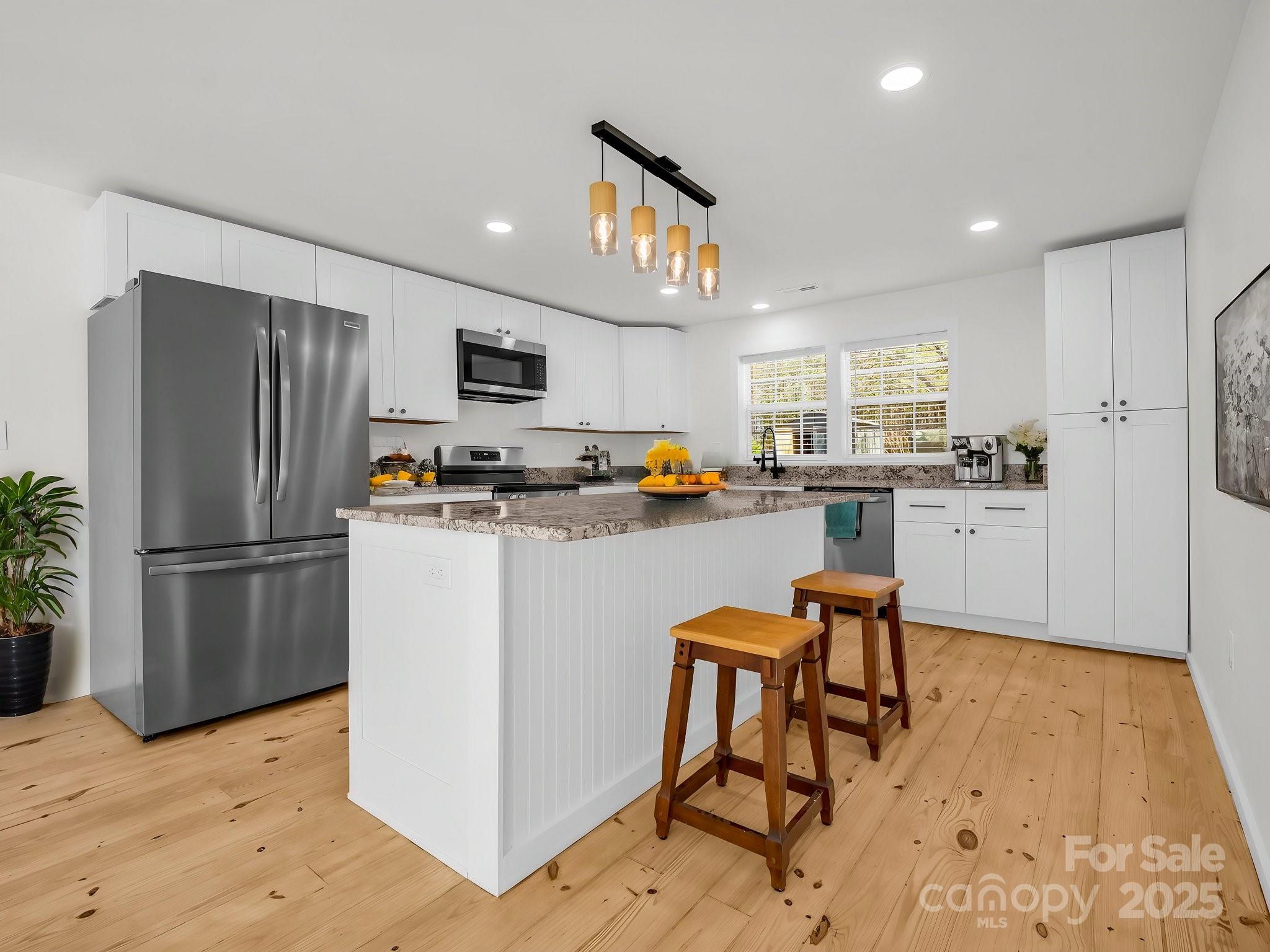 3531 Big Level Road Mill Spring, NC 28756 - Photo 5 of 29 a kitchen with stainless steel appliances granite countertop a refrigerator and a stove top oven