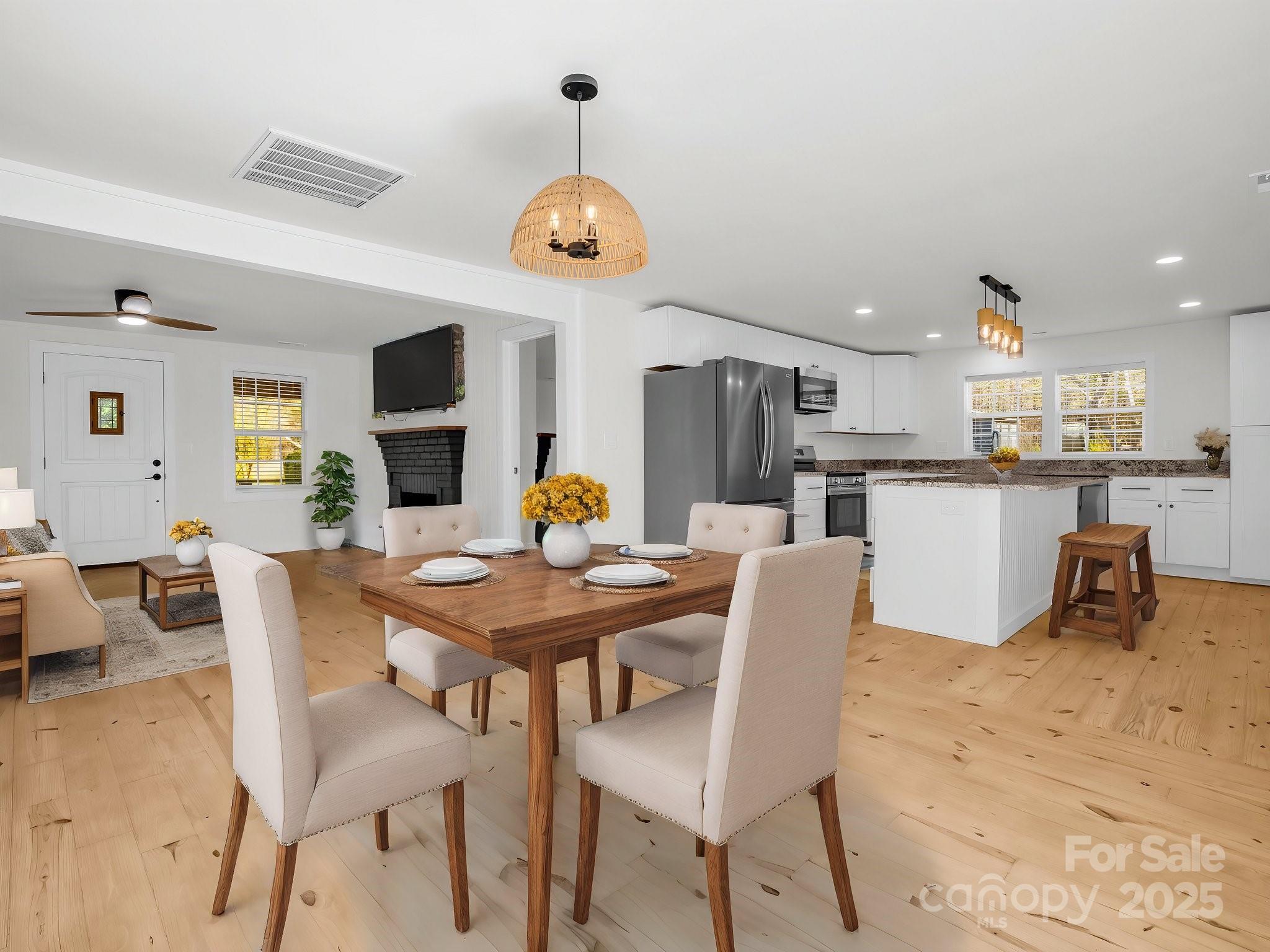 3531 Big Level Road Mill Spring, NC 28756 - Photo 6 of 29 a view of a dining room and a kitchen with a table chairs