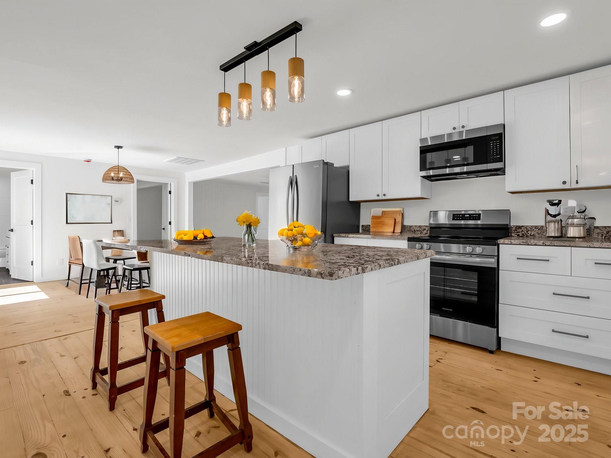 3531 Big Level Road Mill Spring, NC 28756 - Photo 7 of 29 a kitchen with stainless steel appliances granite countertop a stove top oven a sink a stove and a refrigerator