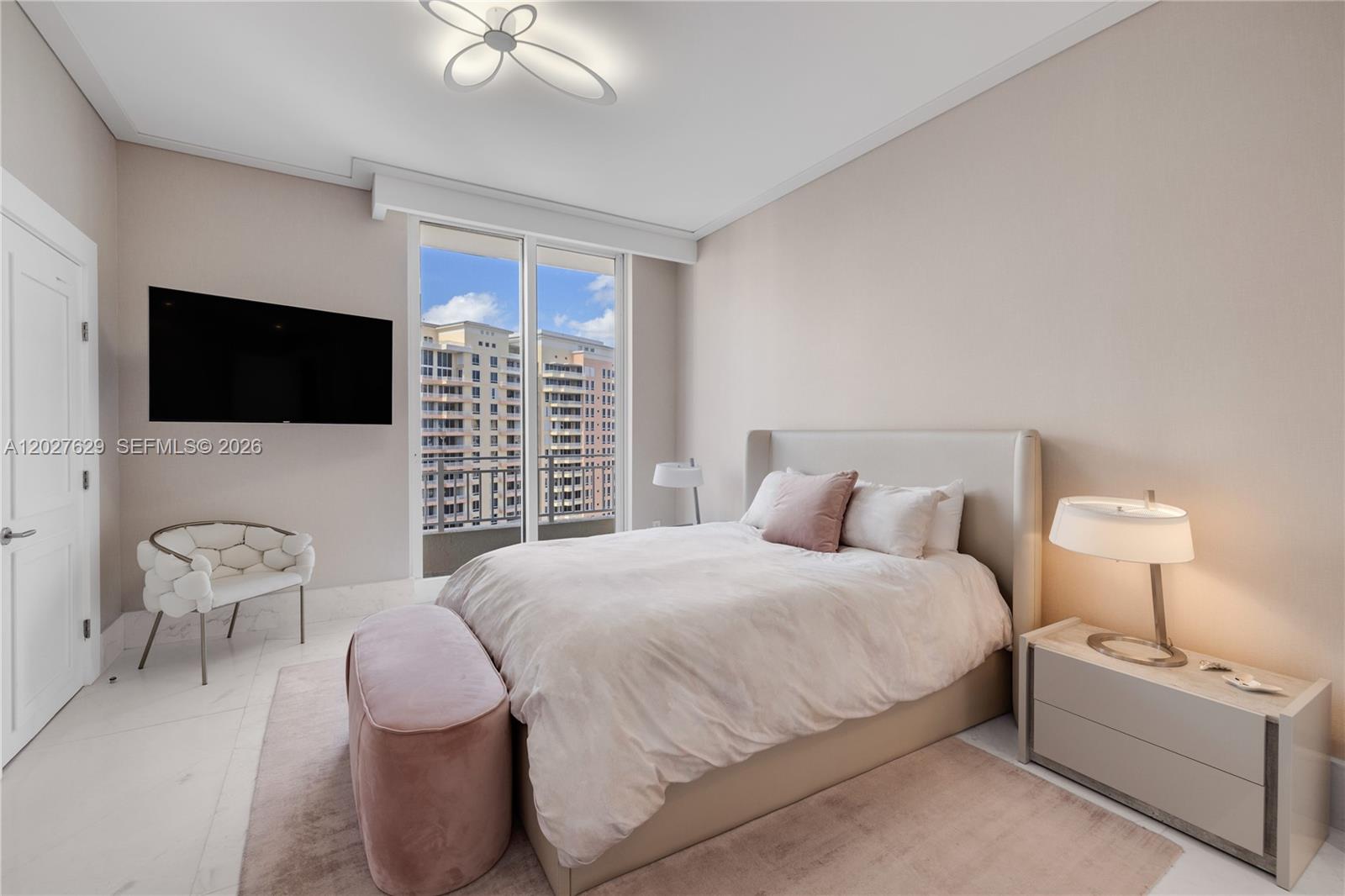 799 Crandon Boulevard, Unit PH8 Key Biscayne, FL 33149 - Photo 16 of 47 a bedroom with a bed and a flat screen tv