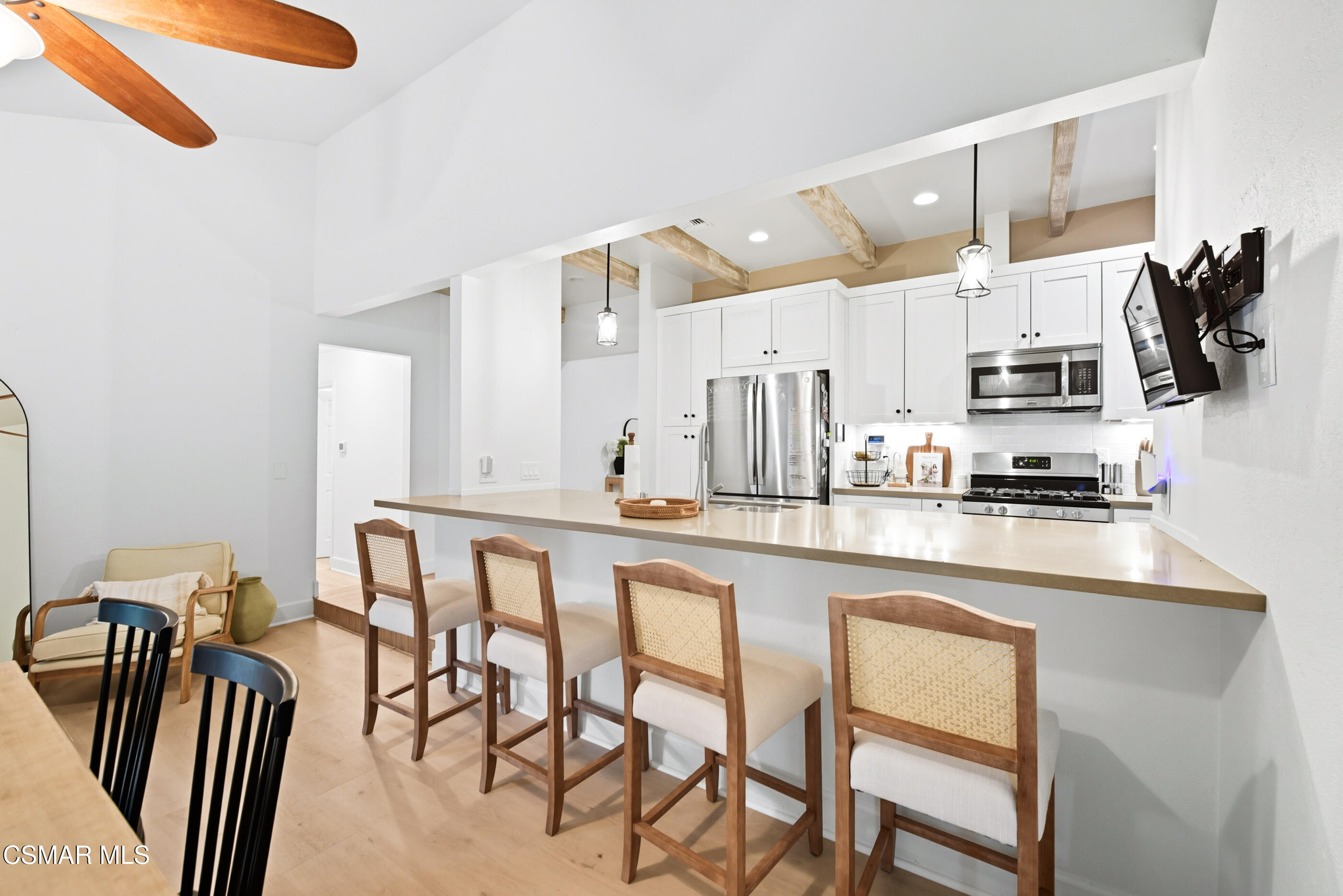 5474 Geoffrey Avenue Simi Valley, CA 93063 - Photo 14 of 38 a kitchen with stainless steel appliances granite countertop a table and chairs in it