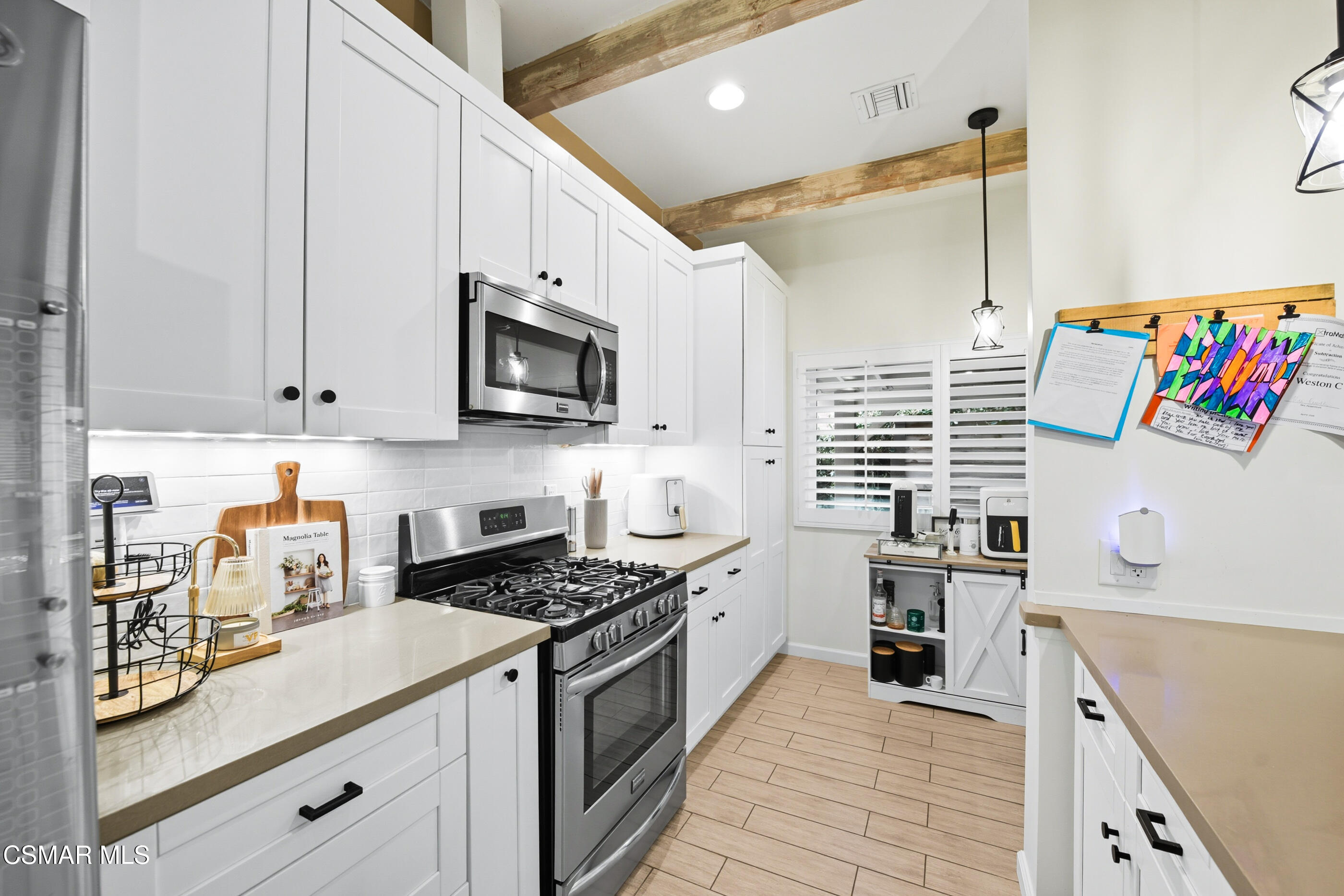 5474 Geoffrey Avenue Simi Valley, CA 93063 - Photo 16 of 38 a kitchen with stainless steel appliances granite countertop a sink and a stove