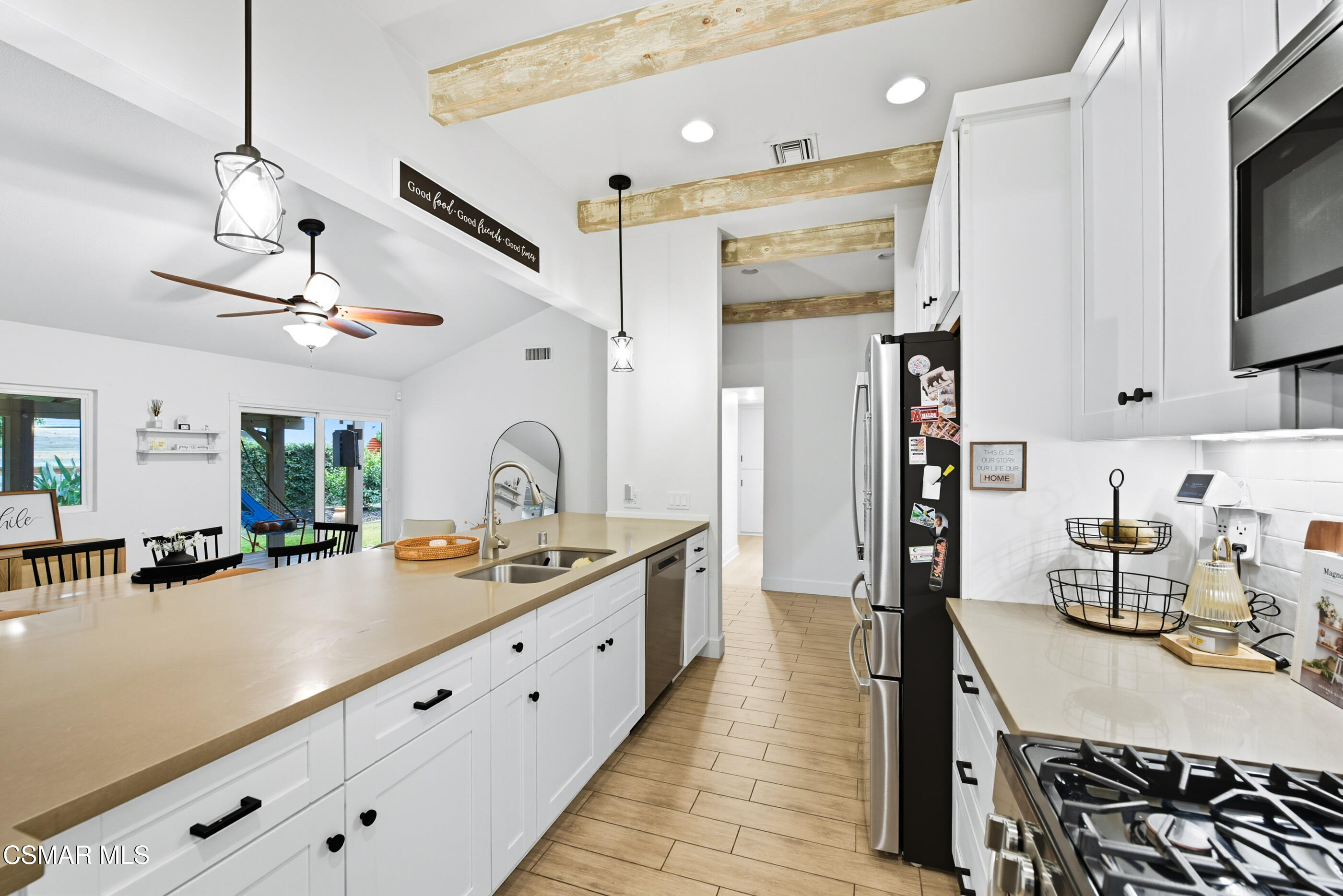 5474 Geoffrey Avenue Simi Valley, CA 93063 - Photo 17 of 38 a kitchen with stainless steel appliances granite countertop a sink stove and refrigerator