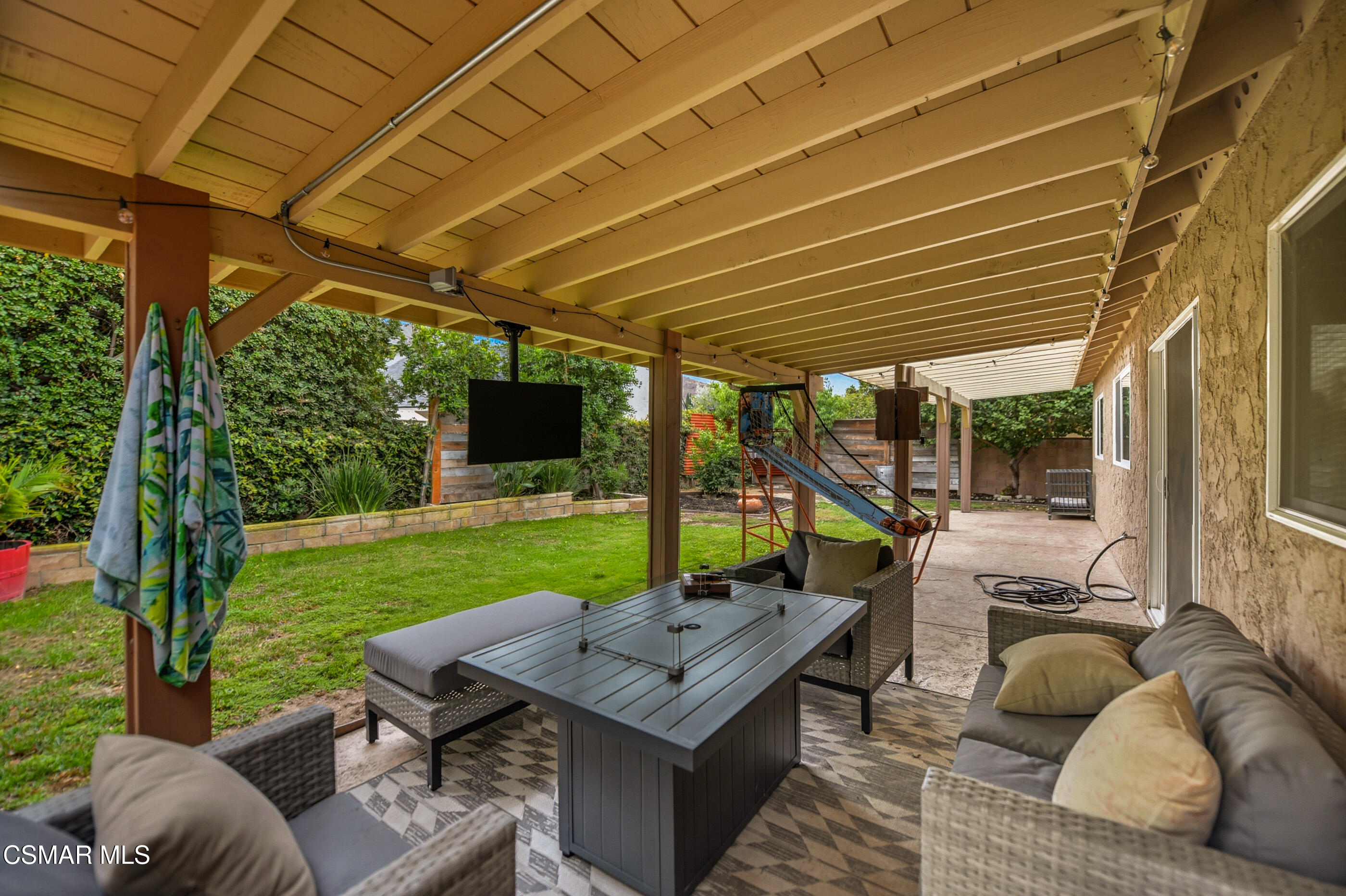 5474 Geoffrey Avenue Simi Valley, CA 93063 - Photo 33 of 38 a view of a patio with couches potted plants and a big yard