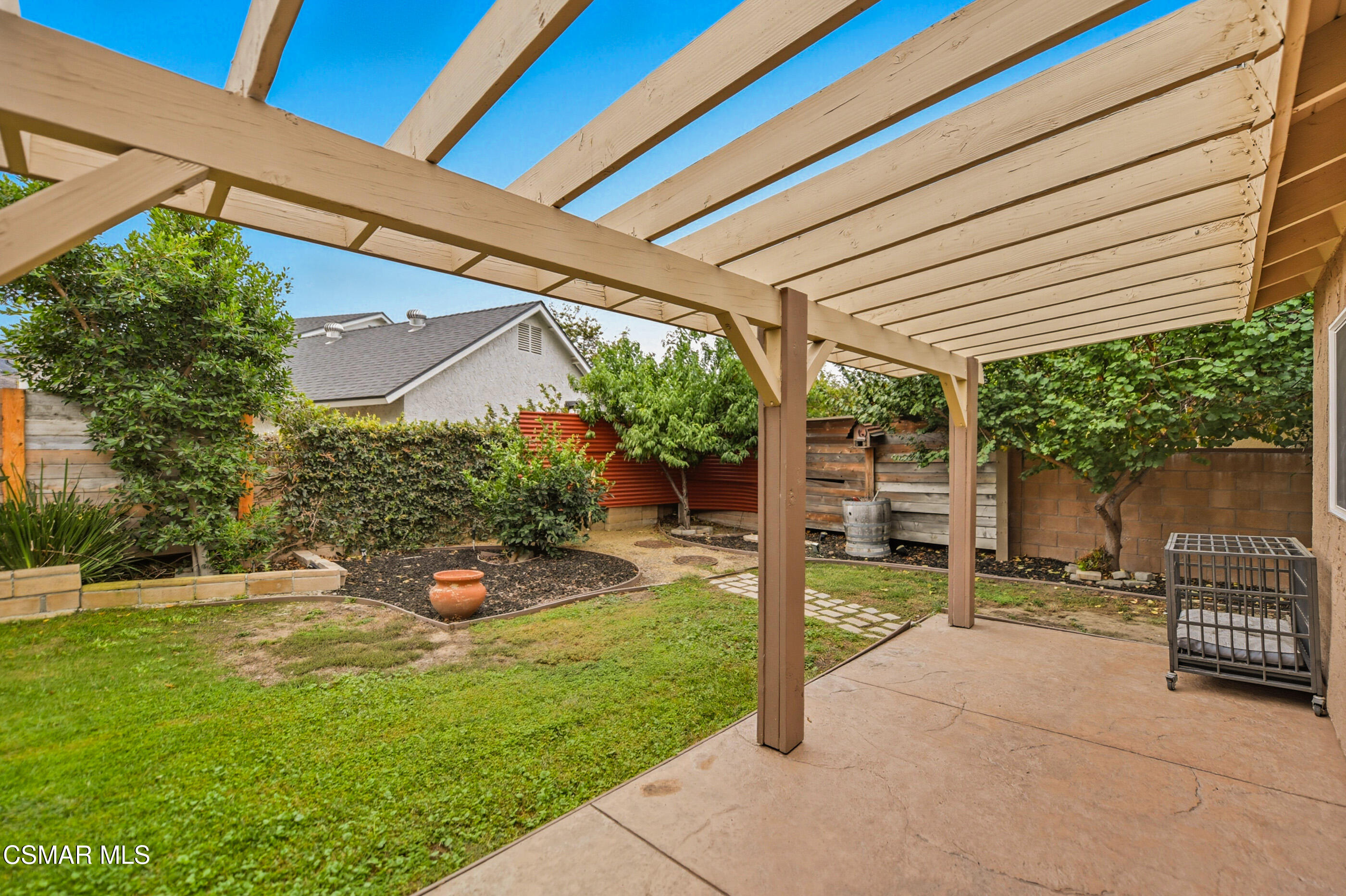 5474 Geoffrey Avenue Simi Valley, CA 93063 - Photo 34 of 38 a view of a chair and tables in the backyard