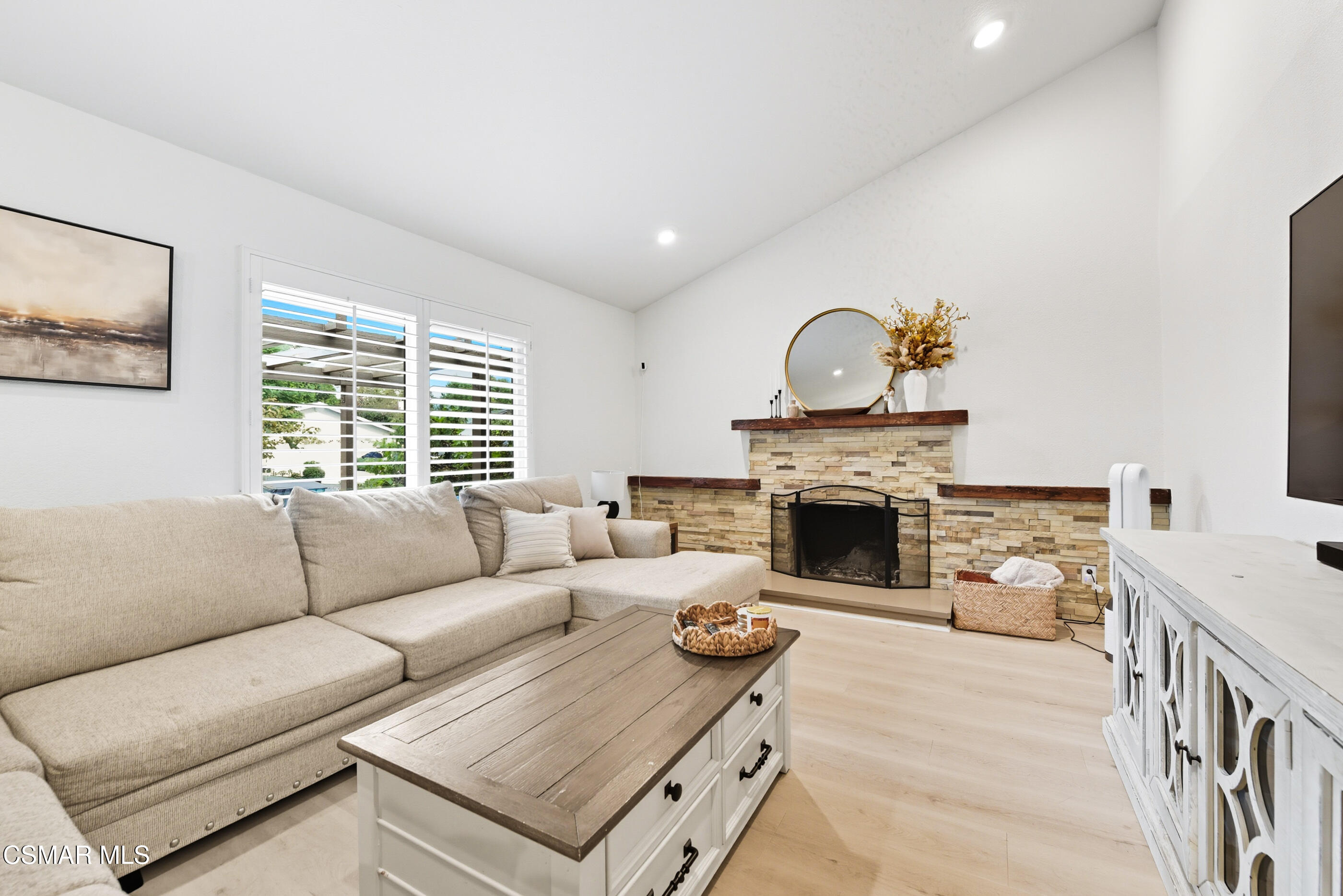 5474 Geoffrey Avenue Simi Valley, CA 93063 - Photo 7 of 38 a living room with furniture a fireplace and a large window