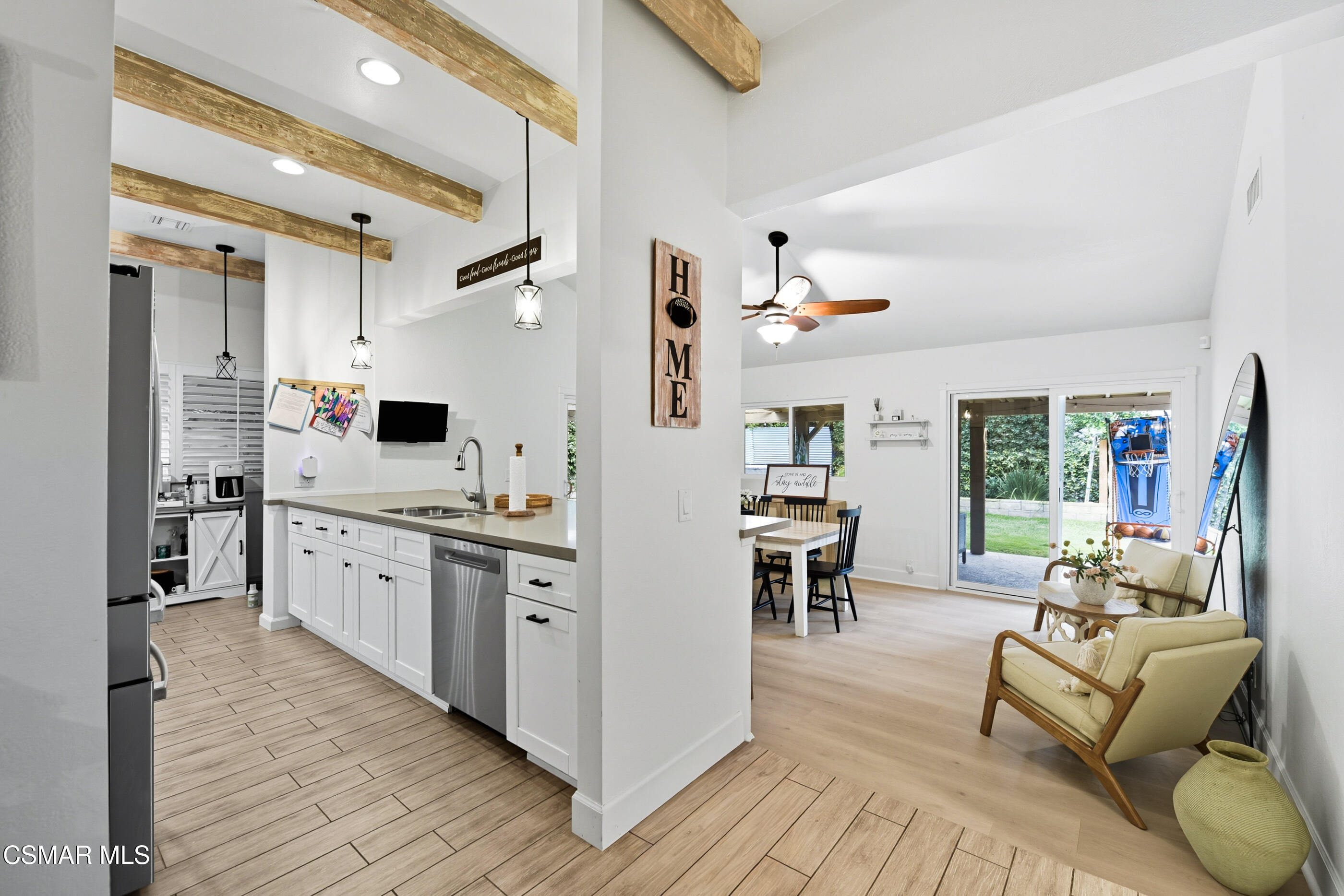 5474 Geoffrey Avenue Simi Valley, CA 93063 - Photo 10 of 38 a large living room with stainless steel appliances furniture a rug and a kitchen view
