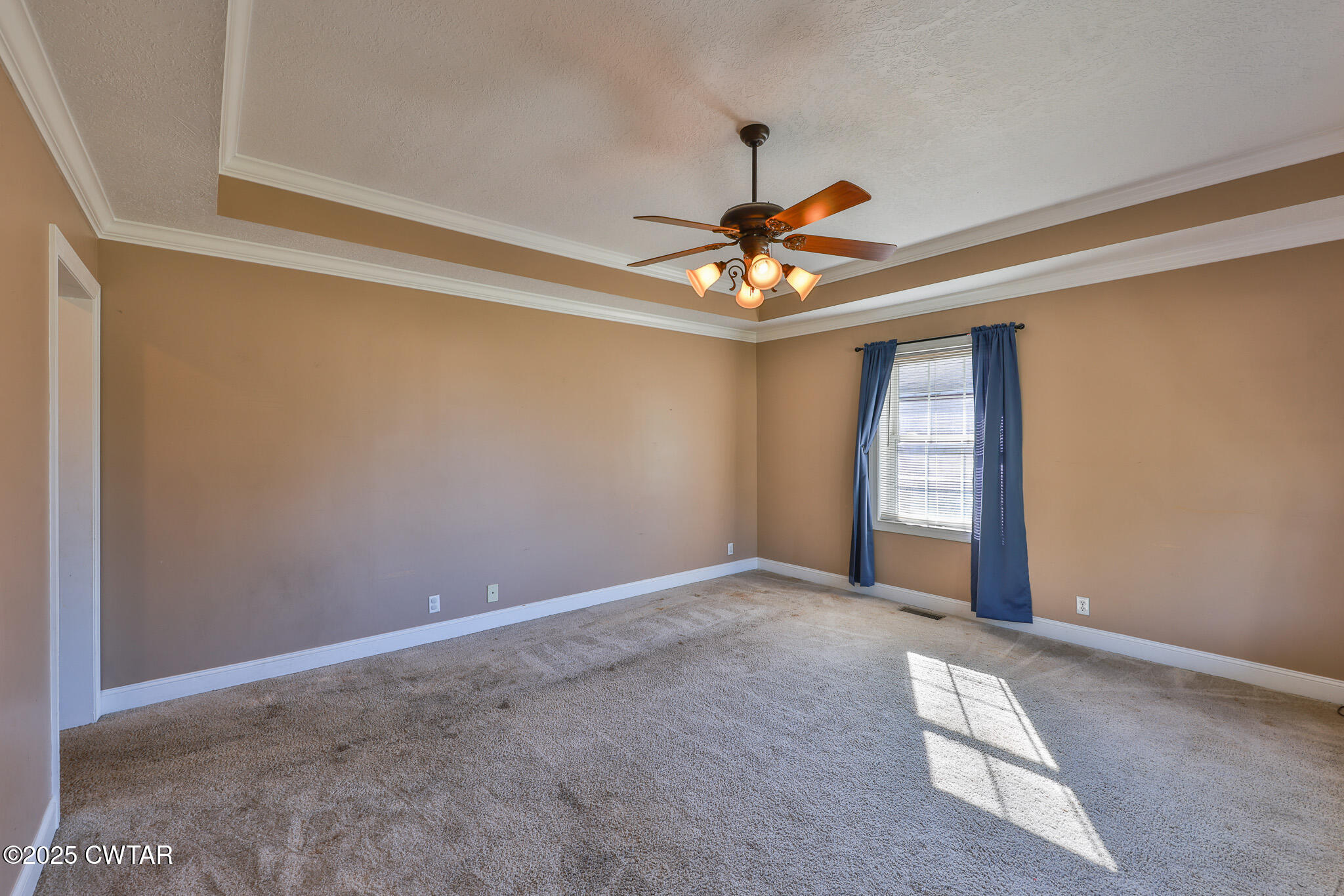 707 North Main Street Dyer, TN 38330 - Photo 13 of 29 en empty room with windows and chandelier fan