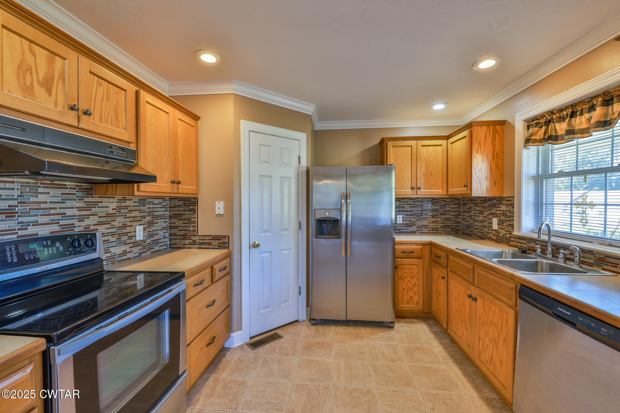 707 North Main Street Dyer, TN 38330 - Photo 16 of 29 a kitchen with stainless steel appliances granite countertop a refrigerator and a sink