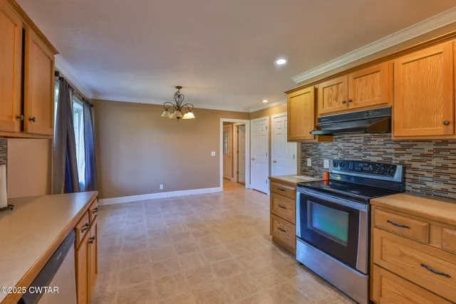 a kitchen with kitchen island a counter top space appliances and a sink