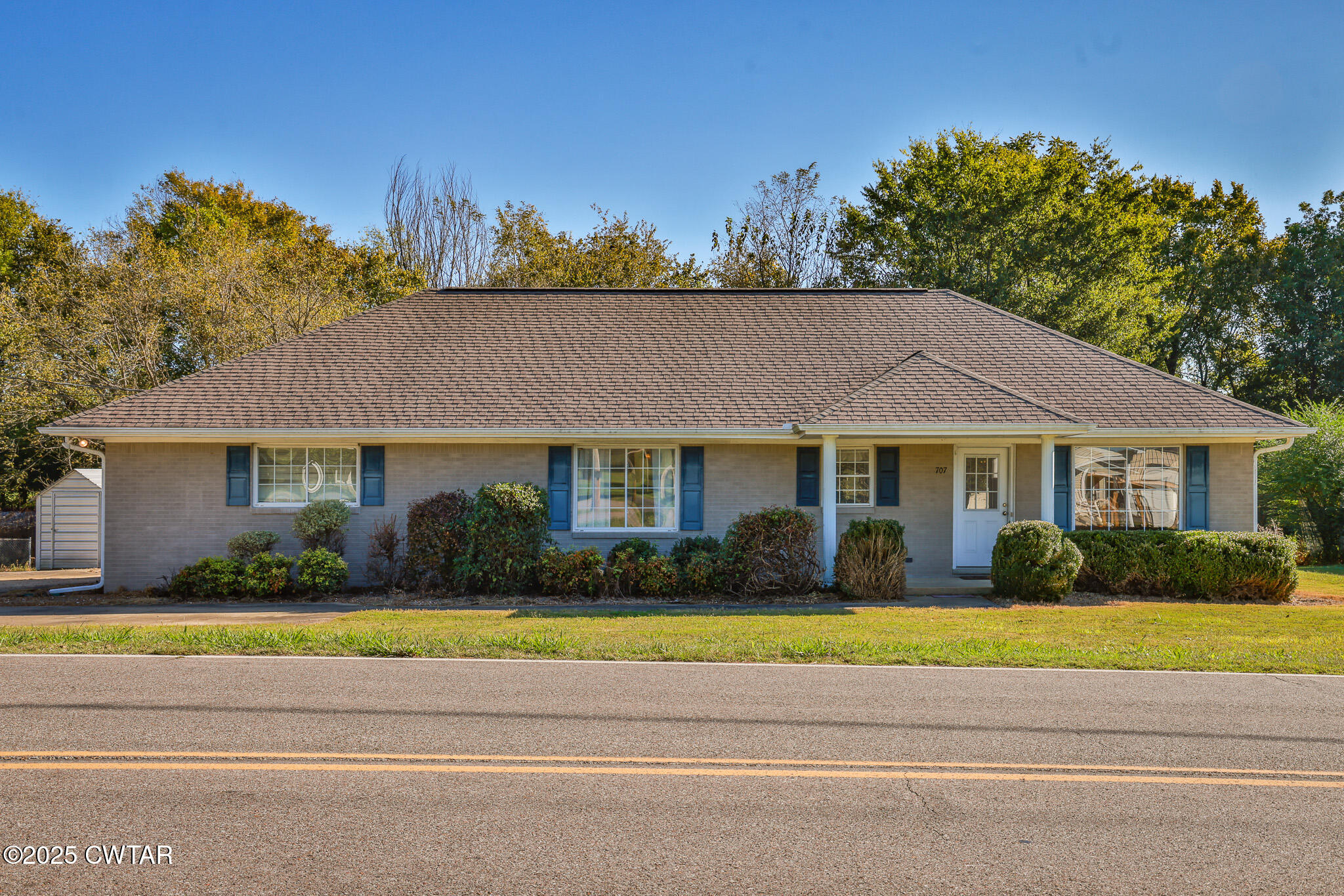 707 North Main Street Dyer, TN 38330 - Photo 5 of 29 a front view of a house with a garden