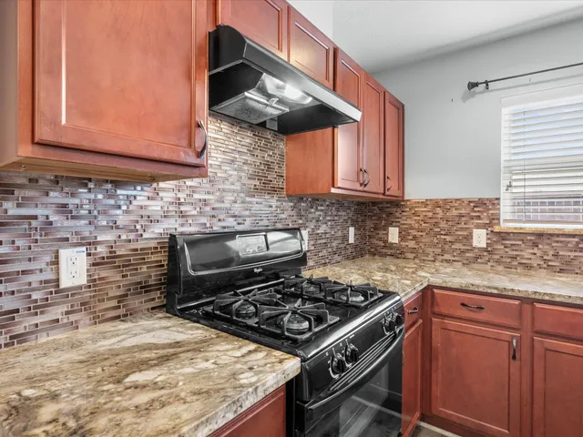 a kitchen with stainless steel appliances granite countertop a stove and a sink