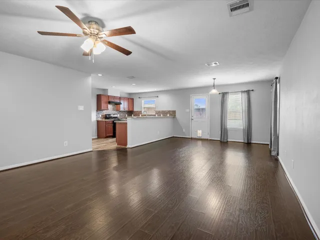wooden floor in an empty room with a window