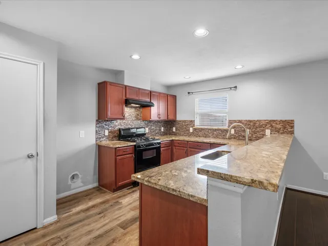 a kitchen with a sink and a refrigerator