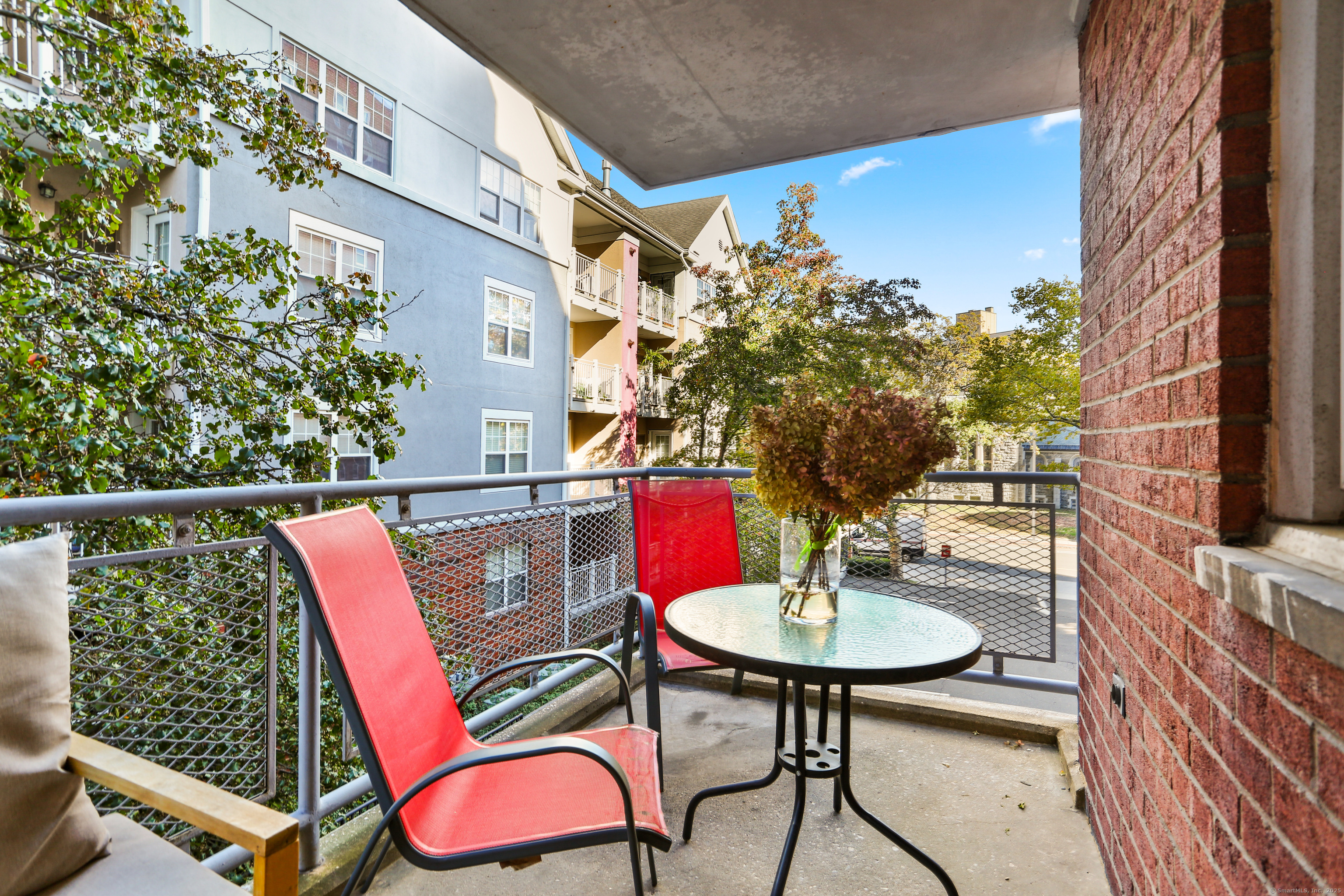 a view of a chairs and table in the balcony