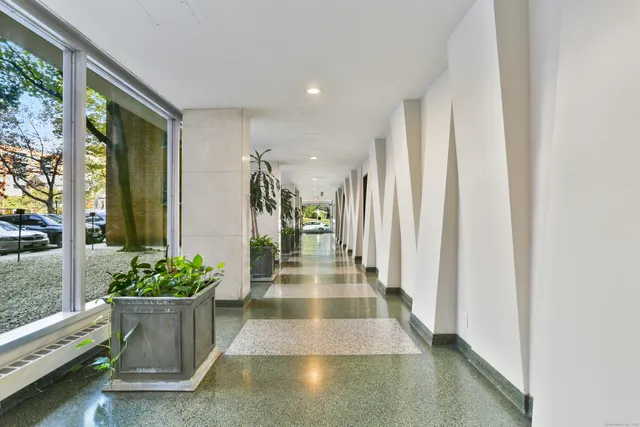 a lobby with furniture and a potted plant