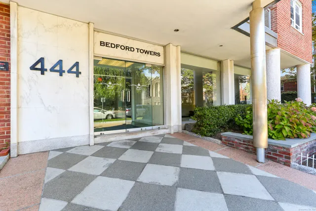 a view of a building with a black and white umbrella