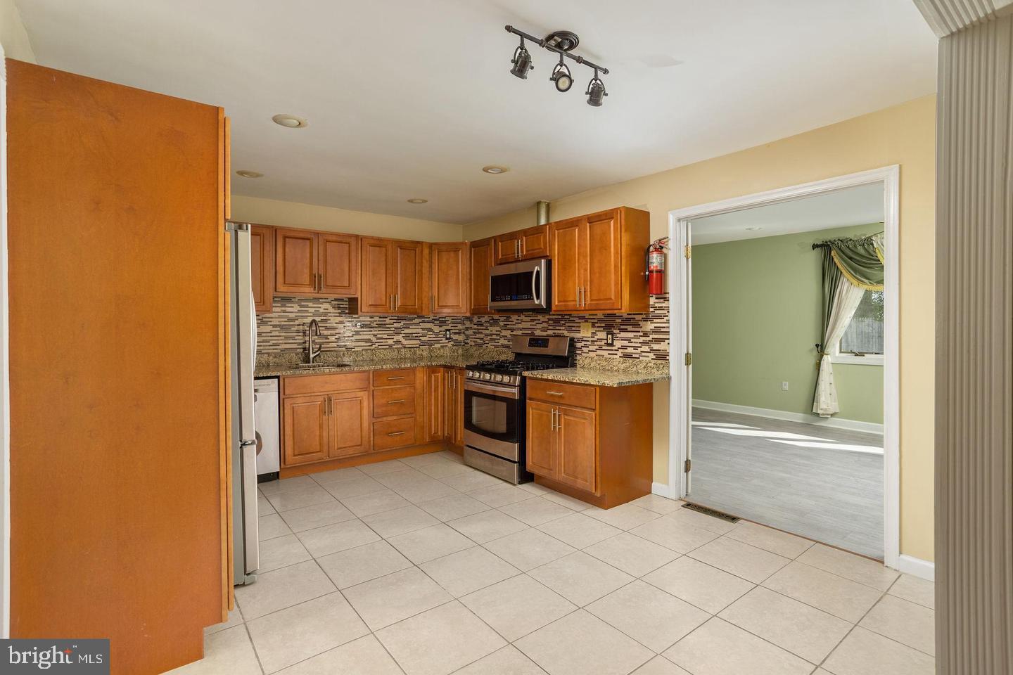 2 Great Oak Road Hamilton, NJ 08690 - Photo 2 of 15 a kitchen with stainless steel appliances granite countertop a stove a sink and a refrigerator