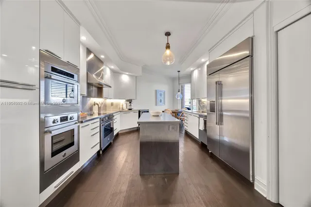 a kitchen with cabinets and stainless steel appliances