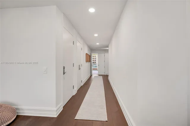 a view of hallway with wooden floor